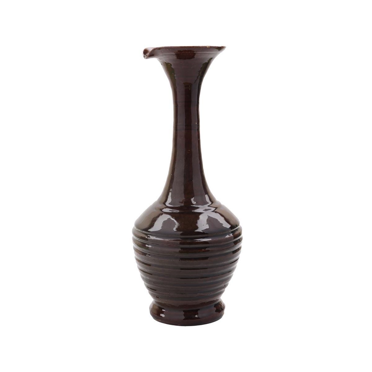 A tall dark brown glazed vase with a long neck and ribbed body.