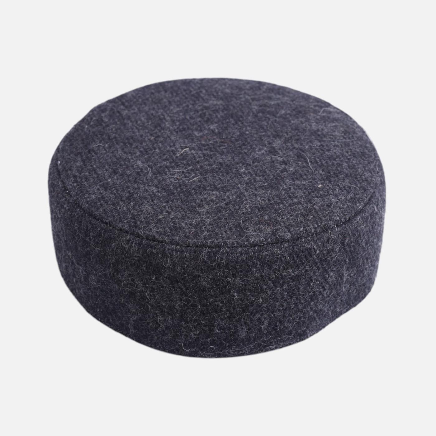 A round charcoal grey felt cap.