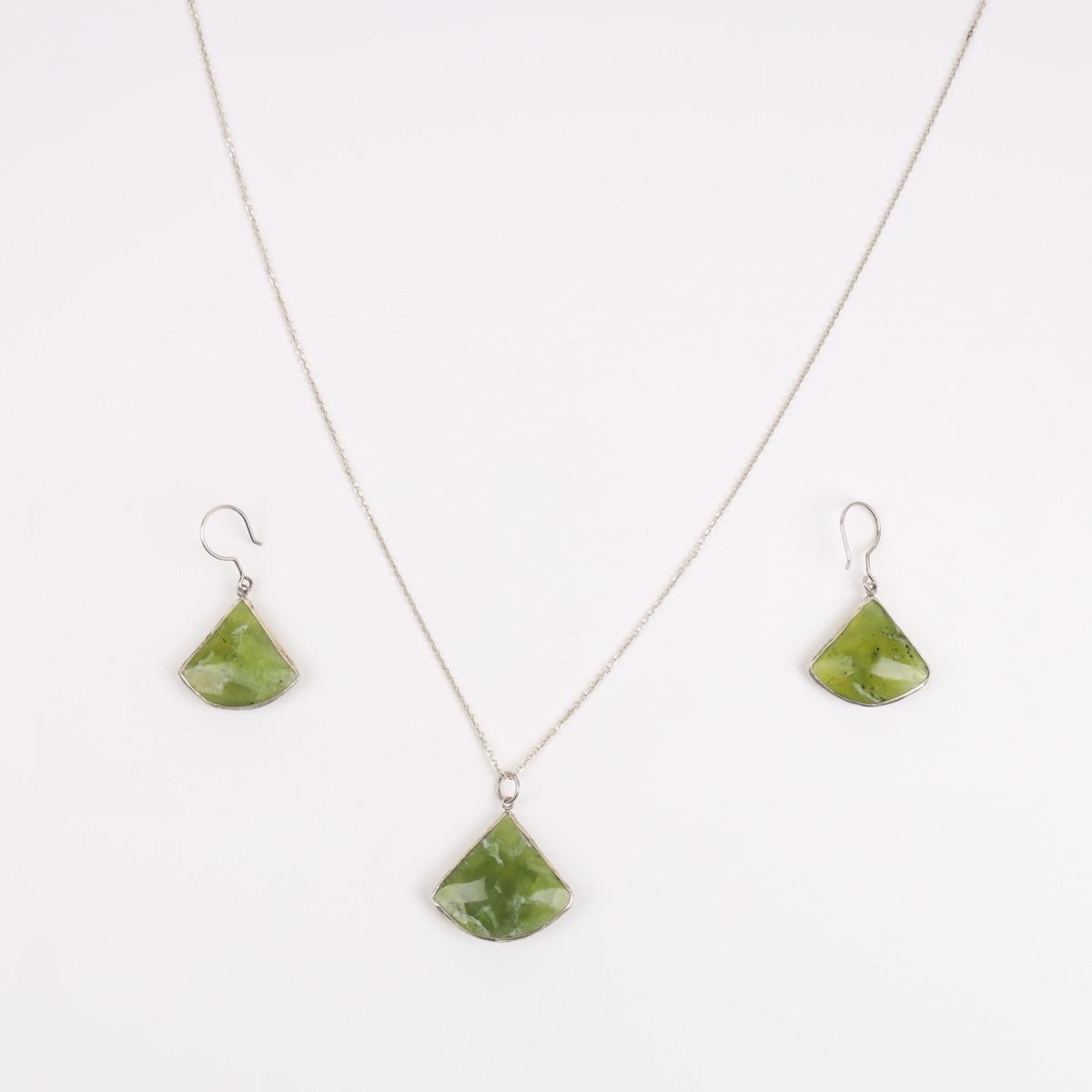A silver necklace and earrings with fan-shaped green peridot stones.