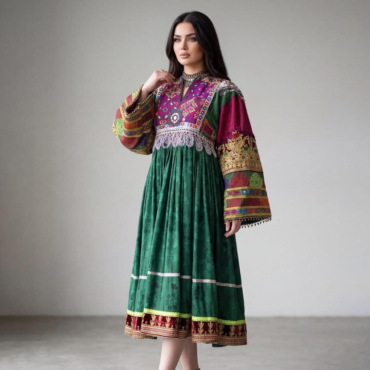 A woman in a long green velvet dress with a richly embroidered purple yoke and patterned sleeves.