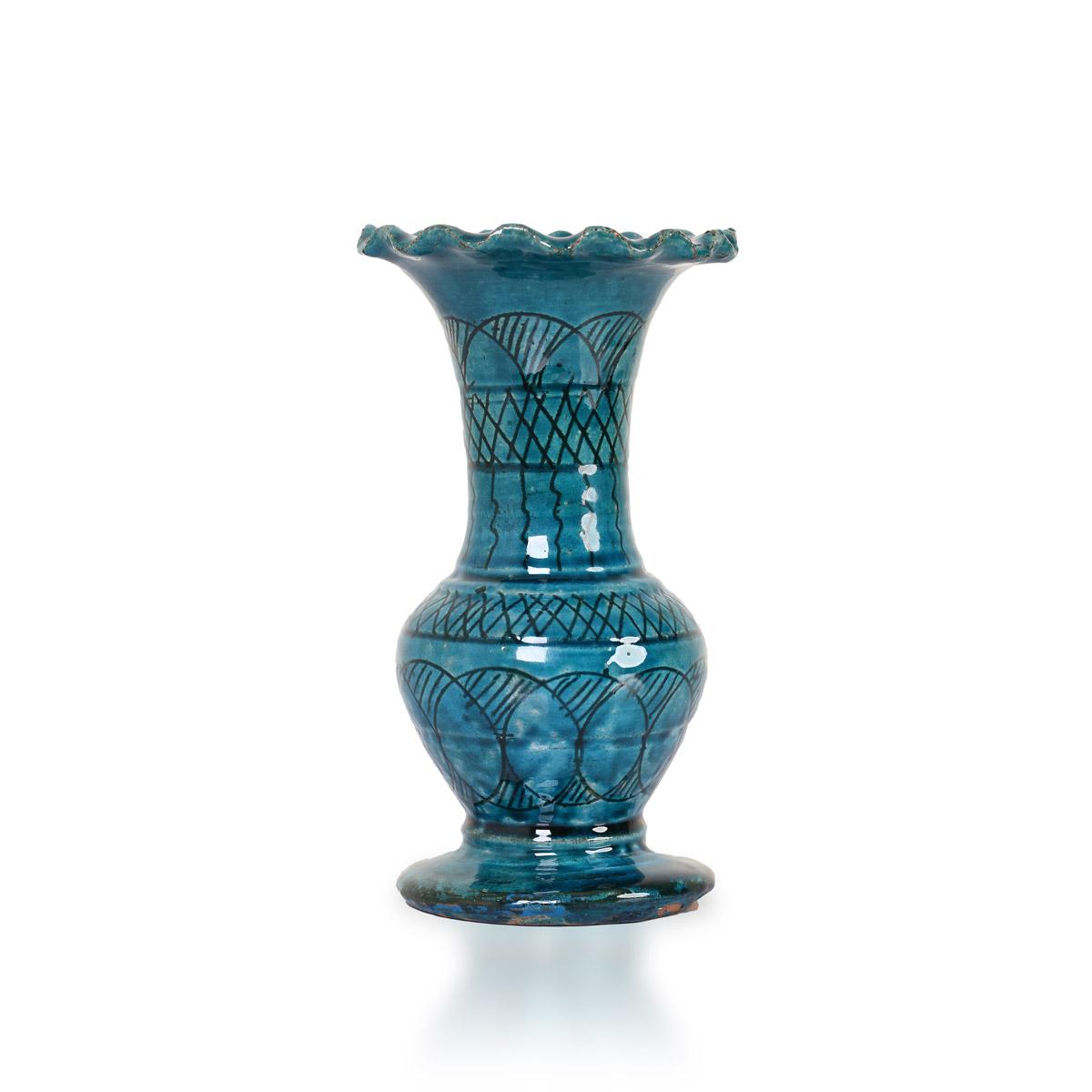 A small deep turquoise vase with a frilled rim and incised pattern.