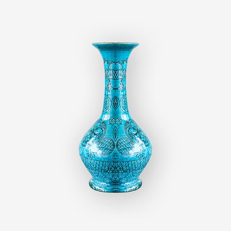 A turquoise glazed vase with a long neck, a flared rim and a dark geometric pattern.