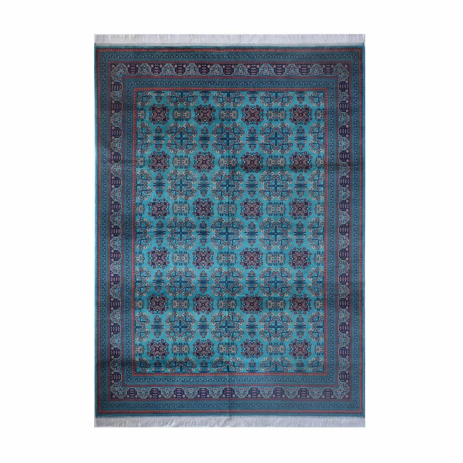 A rectangular rug with a turquoise ground of repeating rosettes and a navy border.